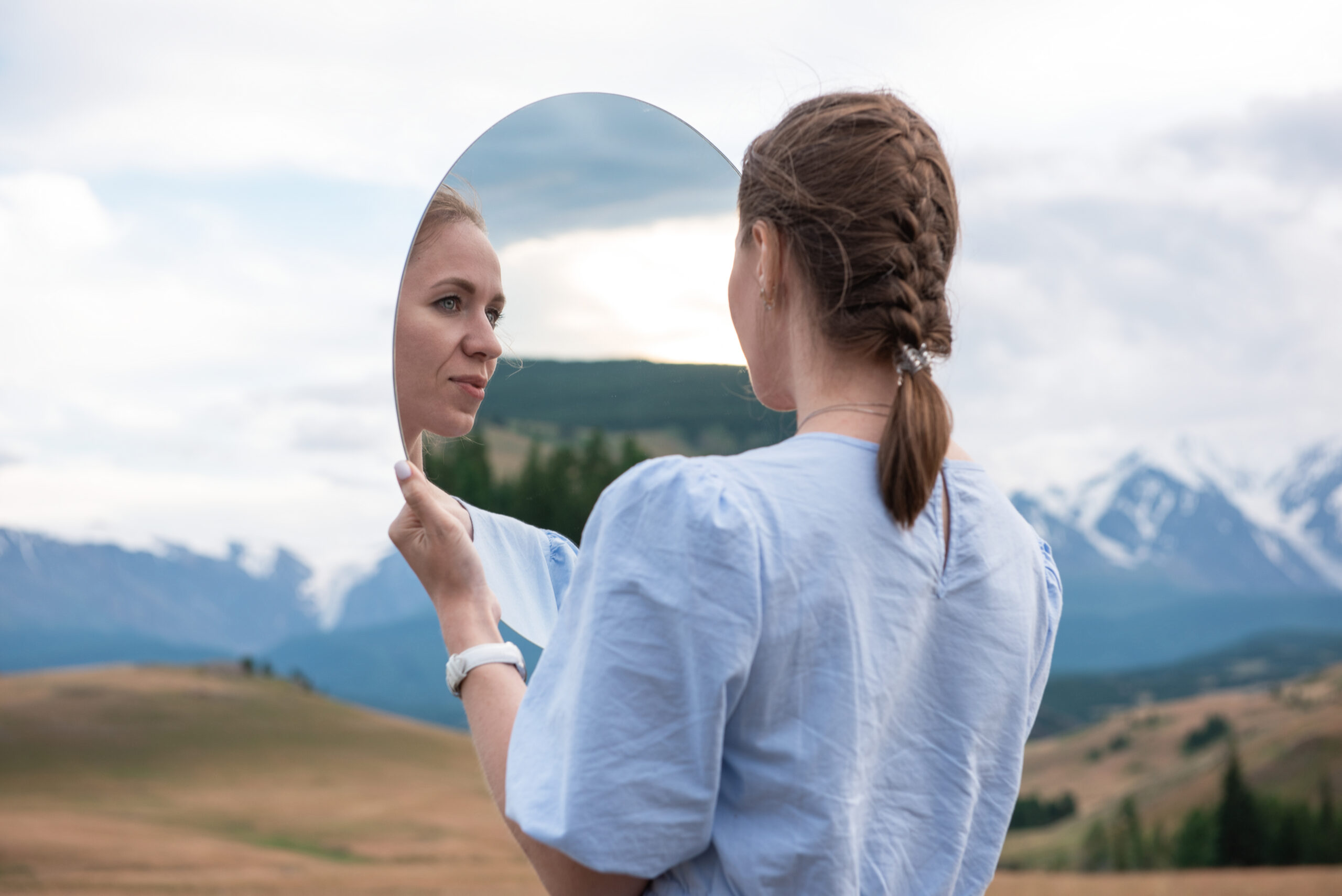 Woman in blue dress in summer Altai mountains
